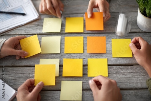team collaboration with sticky notes on desk