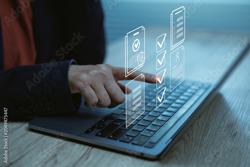 Business professional using laptop with digital checklist interface workflow management, online approval process, task tracking, compliance audit, document verification, and productivity
