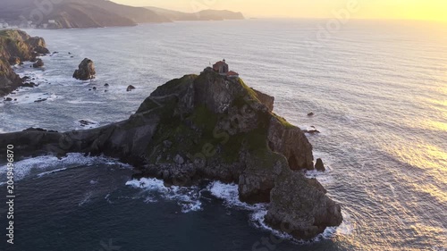 San Juan de Gaztelugatxe, Spain HDR drone video. Aerial view of the lonely hermitage perched atop a towering rocky islet above the ocean off the coast of Basque Country in northern Spain. 
