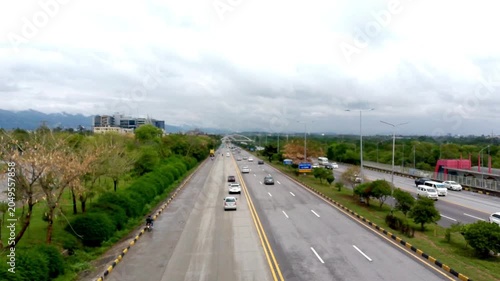 Islamabad Highway View with Cars, Greenery, and Cloudy Sky