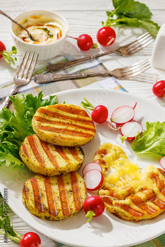 grilled cheese rounds on a plate with radishes