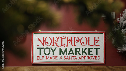 Photos Festive Christmas holiday sign for north pole Toy Market featuring green and red