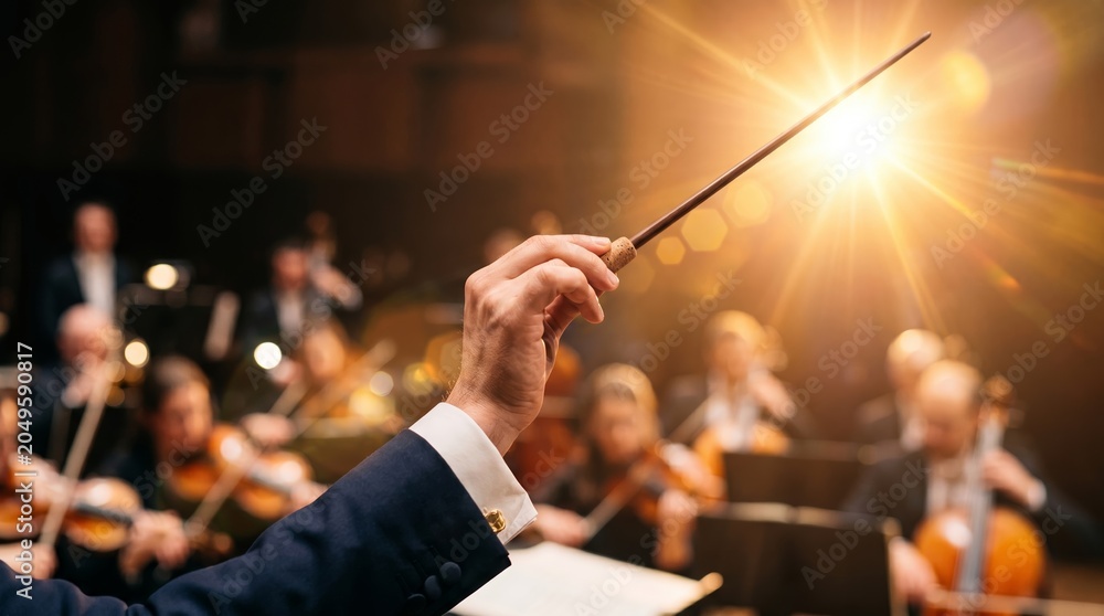 Fototapeta premium A conductor's hand guides an orchestra, backlit by stage lights. Concept: music direction, live performance, classical music, creating an inspirational and dramatic atmosphere. Generative AI.