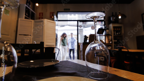A man and a woman entering a restaurant