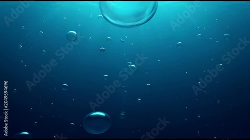 The video depicts an underwater scene, showcasing various air bubbles rising toward the surface