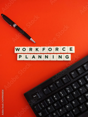 Workforce planning concept with keyboard and pen