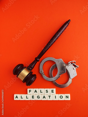 False allegation concept with gavel and handcuffs