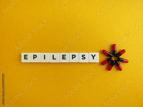Epilepsy word spelling out with medicine capsules