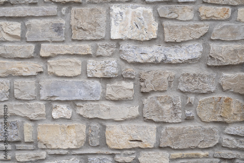 Close-up of natural stone wall with rough masonry pattern. Construction and architectural background.
