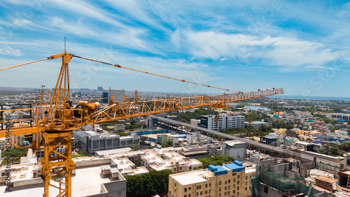 Aerial View Of Tower Crane And Urban Development In Growing City