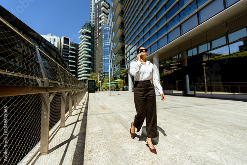 Businesswoman walks on city...