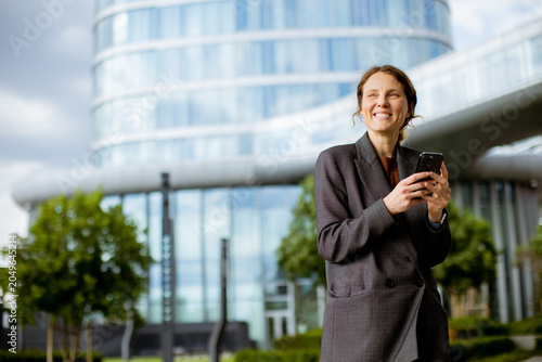 Woman stands outside modern...
