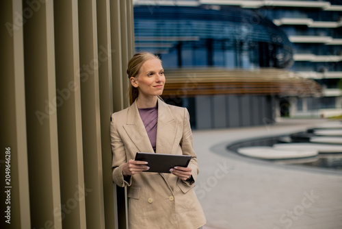 Woman using tablet while st...