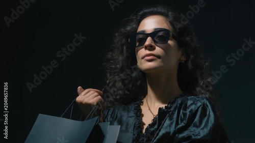 Woman With Sunglasses Shopping Holding Bags Outdoors Warm Sunlight