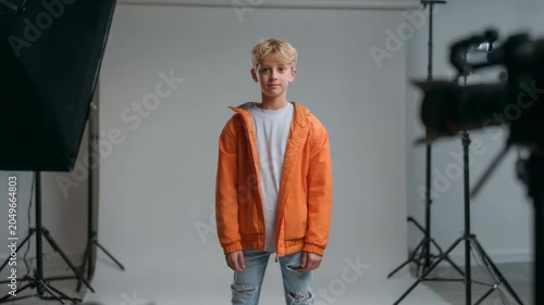 Young Boy Posing Confidently in Studio with Professional Lighting