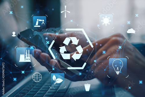 Recycling and sustainability technology icons floating over hands using smart...