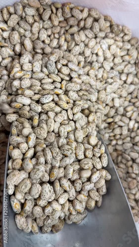 Pinto beans with metal scoop, suitable as culinary ingredient and background for food-themed designs