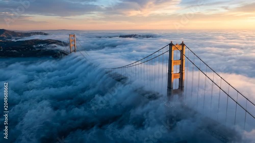 Advection Fog Rolls Over Suspension Bridge Towers at Sunrise