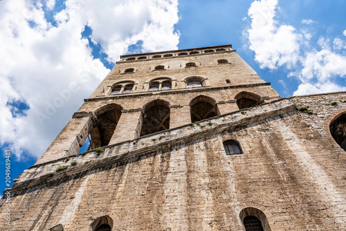 Low angle view from Via Baldassini of Palazzo dei Consoli, medieval landmark in historic center, Gubbio, Umbria, Italy