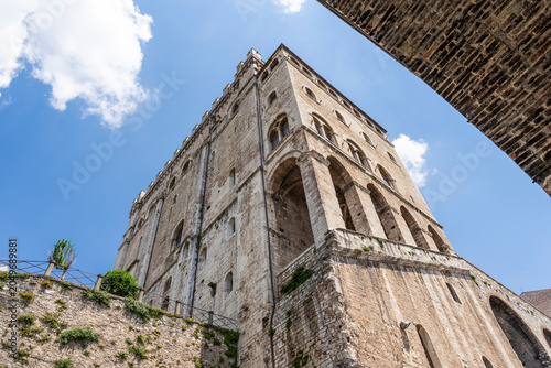 Low angle view from Via Baldassini of Palazzo dei Consoli, medieval landmark in historic center, Gubbio, Umbria, Italy 