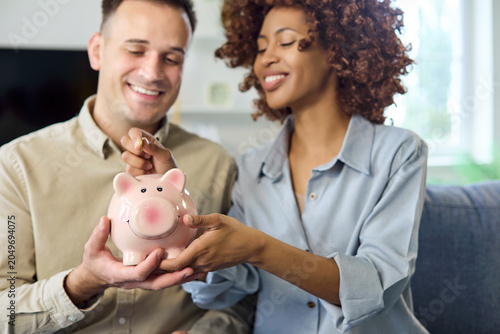Canvas Print man woman with piggybank savings money