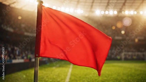 Corner flag on a vibrant green soccer field during a professional championship match with spectators in the background, a sunny day