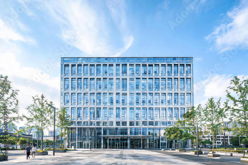 Modern office building with glass facade and open plaza in urban environment