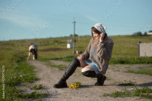 Konstfotografi Enjoying a warm afternoon in nature while kneeling to admire a bouquet of wildfl