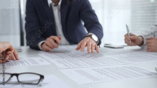 Fotografie Business team collaborating at a conference table, reviewing documents and using