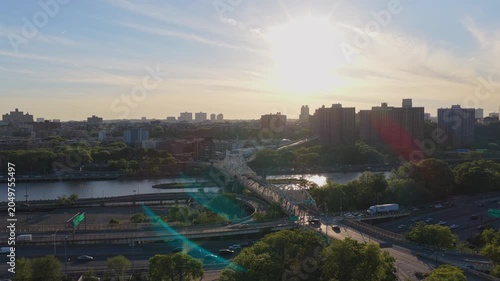Urban infrastructure in South Bronx with Bruckner Expressway traffic and Willis Avenue Bridge crossing Harlem River at sunset, capturing daily city life in New York