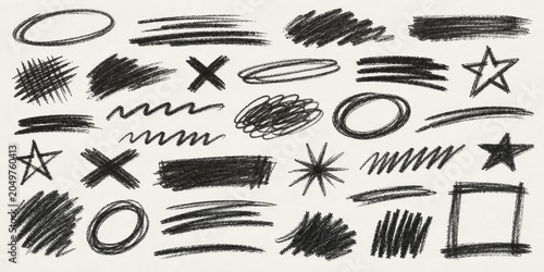 Collection of diverse charcoal scribbles, brush strokes, asterisks, crosses, and oval shapes