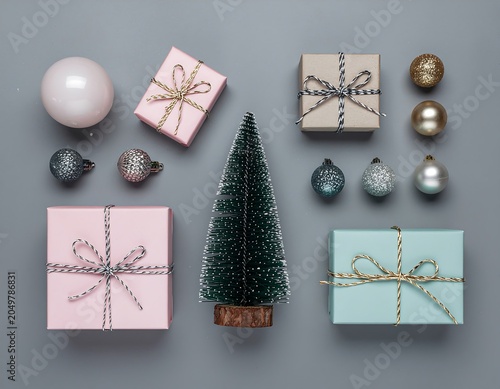 Festive Christmas gifts and decorations on gray background.