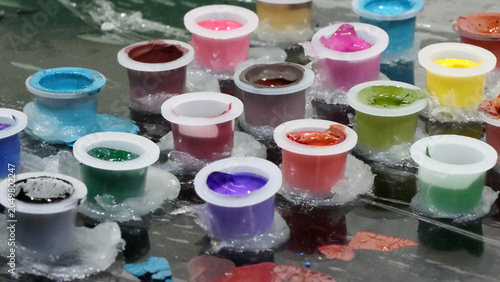 Colored inks in caps or containers ready for tattooing or painting
