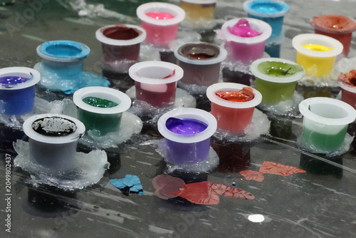 Colored inks in caps or containers ready for tattooing or painting