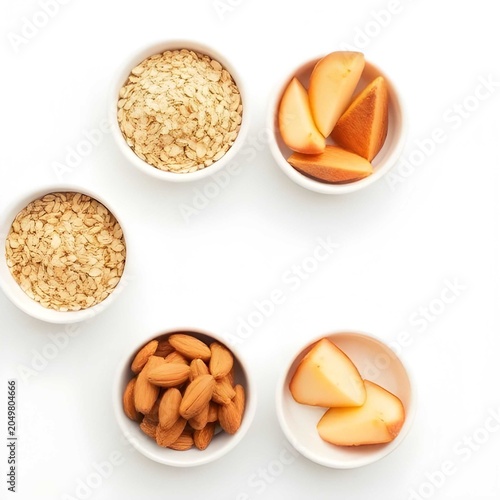 Healthy gut foods arrangement with almonds, oats, and fresh fruit in white bowls