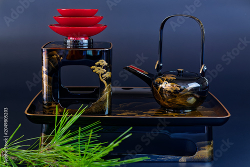 Traditional Japanese lacquerware tea set with black and red bowls
