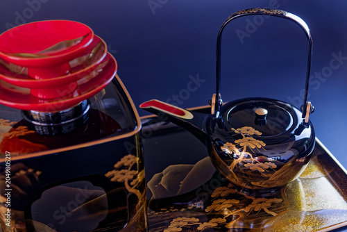 Close up of traditional Japanese lacquerware bowls and teapot