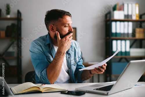 Man worrying about financial problems and paperwork