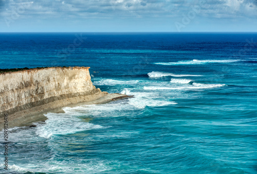 Rocky coastal cliffs with turquoise ocean and blue sky