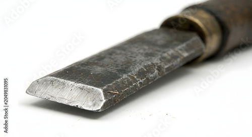 Macro detail of an aged antique chisel blade edge, showing metal texture and patina.