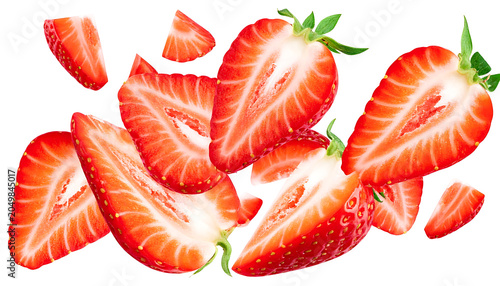 Fresh sliced strawberries falling and splashing, bright red fruit halves and pieces isolated on white background, healthy food concept