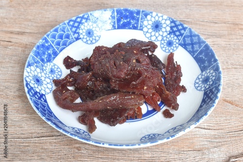 salty and sweet dry fried slice beef meat jerky fermenting in sesame oil and pepper on plate