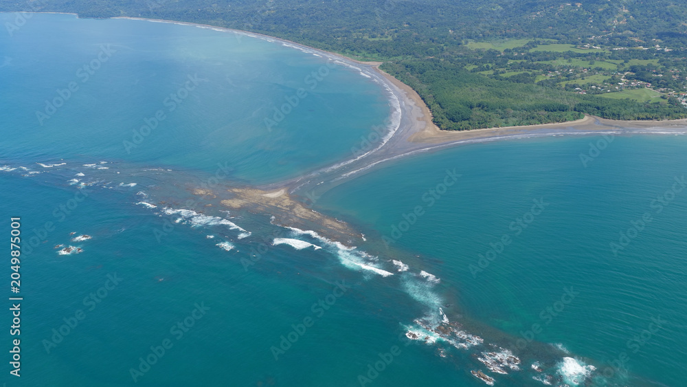 Obraz premium Aerial view of the iconic Uvita whale tail sand formation merging with the coastline during a low tide in Costa Rica
