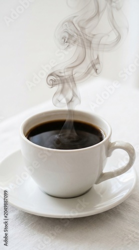 Steaming cup of coffee on saucer
