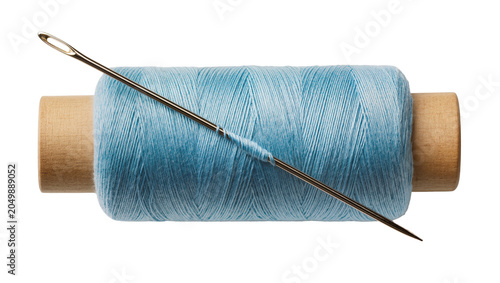 Obraz na płótnie Metal sewing needle threaded through a spool of light blue cotton thread, isolat