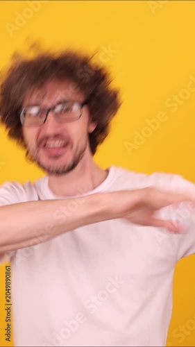 Person raising arms in an energetic celebratory pose, expressing a joyful winner mood and dynamic victory dance emotion against a bright yellow background.