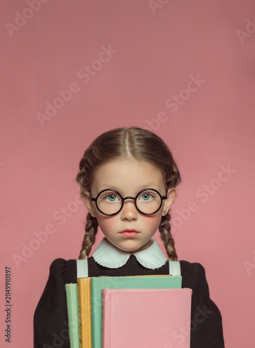 Serious Girl with Glasses and Braids Holding Books – Studio Education Portrait