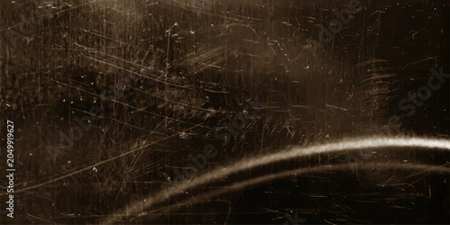 Foto A textured, weathered metal surface with numerous scratches, scuffs, and a distinctive curved highlight, evoking a sense of age and durability