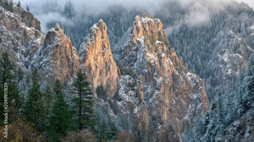 Snow Capped Mountain Landscape with Rocky Peaks and Forested Slopes in Winter