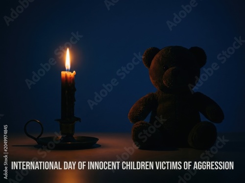 International Day of Innocent Children Victims of Aggression, candle and teddy bear